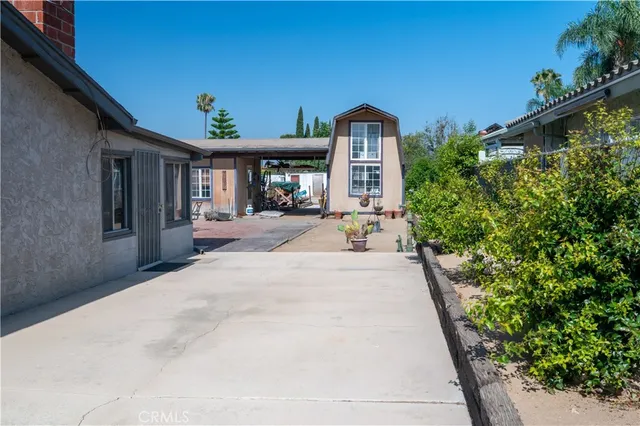 a view of a patio with table and chairs and potted plants
