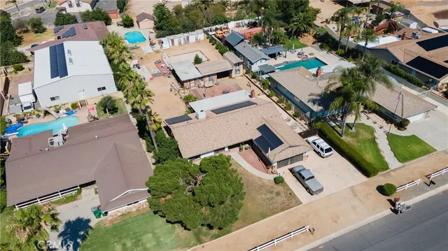 an aerial view of residential houses with outdoor space