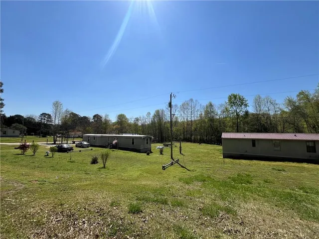 a view of a yard with a house and a trees