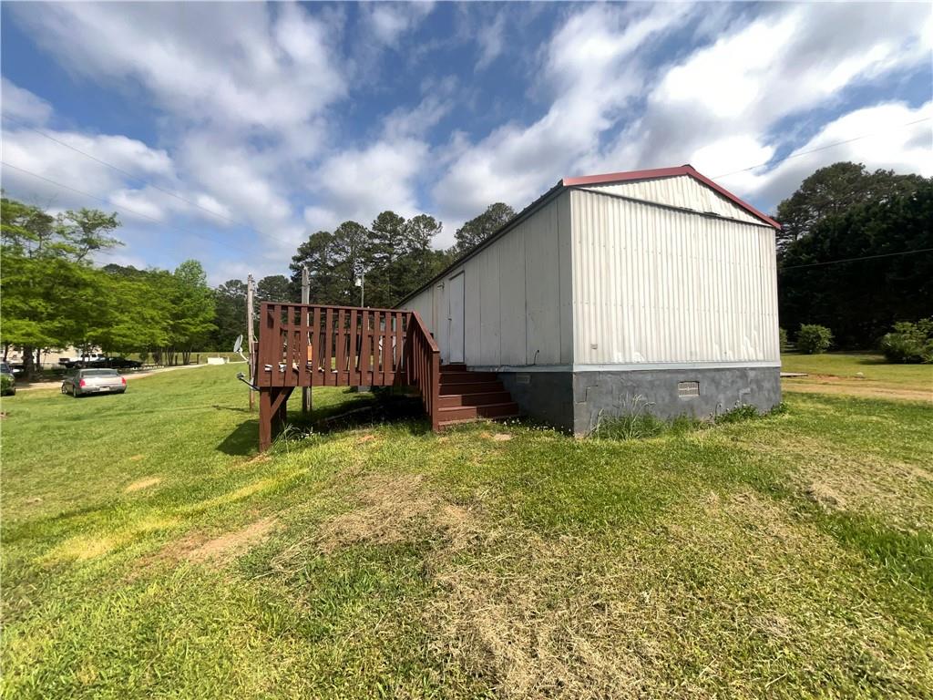 474 Whitney Road Jefferson, GA 30549 - Photo 14 of 55 a backyard of a house with wooden fence and brick wall