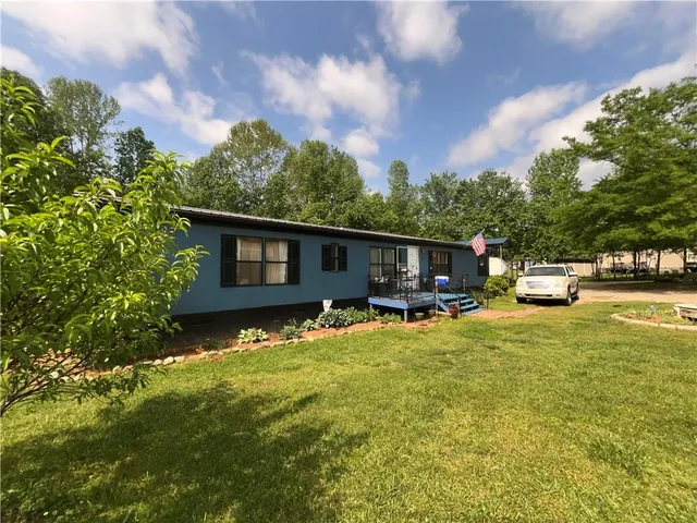 a backyard of a house with yard barbeque oven and outdoor seating