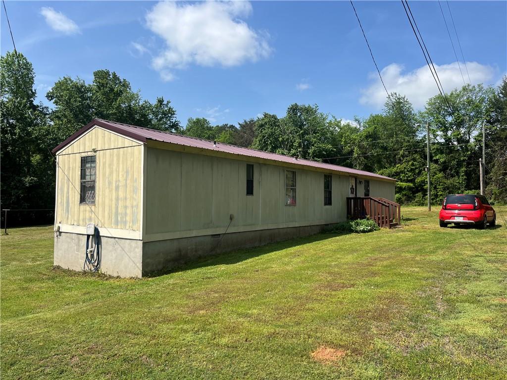474 Whitney Road Jefferson, GA 30549 - Photo 25 of 55 a front view of a house with a yard and garage