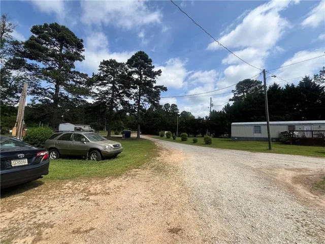 a car parked in the grass near a lake