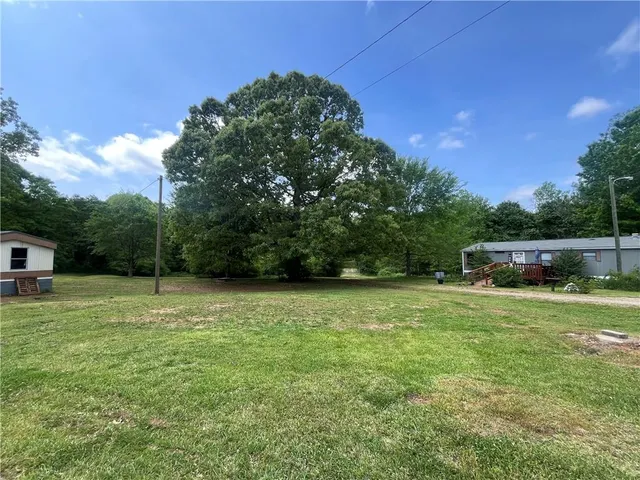 a wooden bench sitting in the middle of a yard