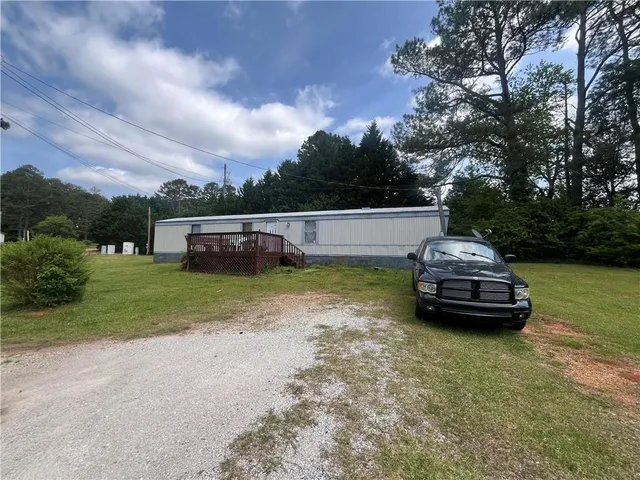 a view of a backyard with plants and a patio
