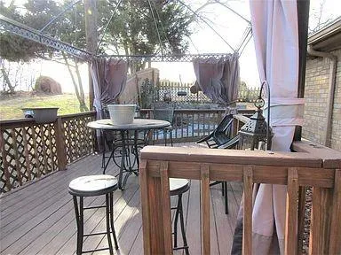 a view of a wooden deck with a yard