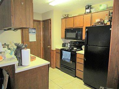 1500 North Grant Drive, Unit A Sherman, TX 75092 - Photo 3 of 14 a kitchen with a refrigerator and a sink
