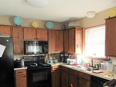 1500 North Grant Drive, Unit A Sherman, TX 75092 - Photo 5 of 14 a kitchen with a sink a stove and cabinets