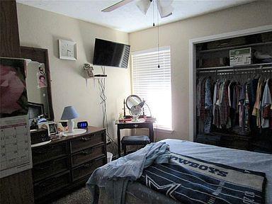 1500 North Grant Drive, Unit A Sherman, TX 75092 - Photo 6 of 14 a bedroom with a bed and a television