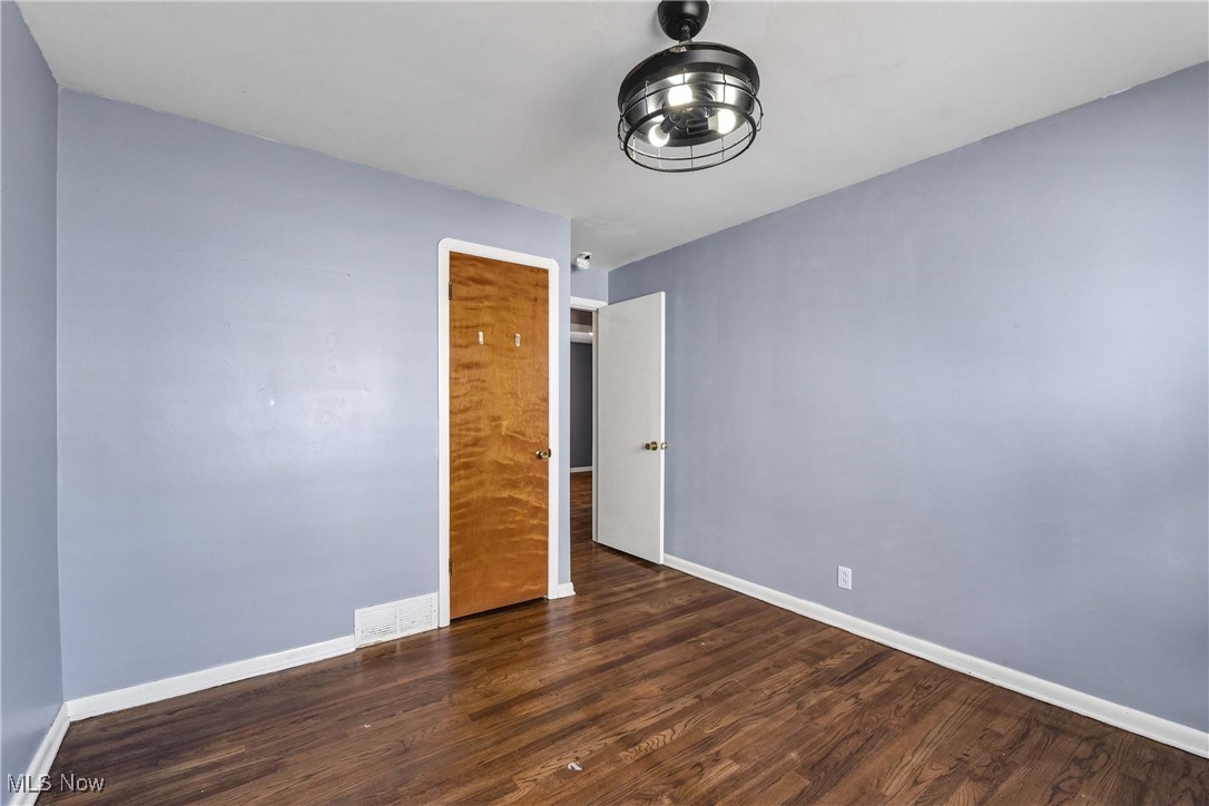 6506 Snow Road Parma, OH 44129 - Photo 14 of 25 Unfurnished bedroom featuring dark wood-style flooring and baseboards