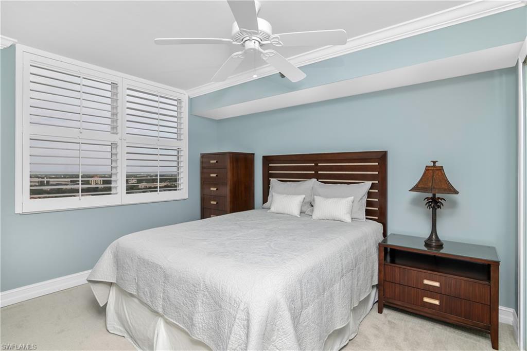 5550 Heron Point Drive, Unit 1804 Naples, FL 34108 - Photo 11 of 20 a bedroom with a bed and a window