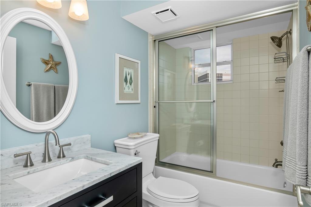 5550 Heron Point Drive, Unit 1804 Naples, FL 34108 - Photo 12 of 20 a bathroom with a sink a toilet and shower