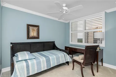 a bedroom with a bed and a table