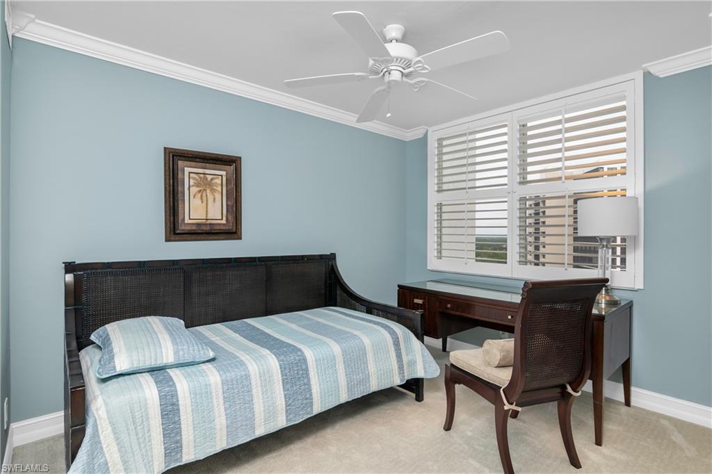 5550 Heron Point Drive, Unit 1804 Naples, FL 34108 - Photo 13 of 20 a bedroom with a bed and a table