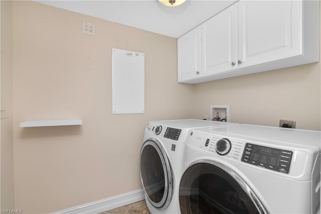 5550 Heron Point Drive, Unit 1804 Naples, FL 34108 - Photo 14 of 20 a utility room with dryer and washer