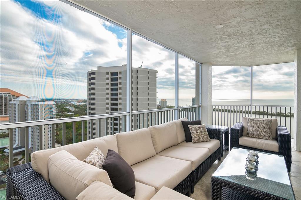 5550 Heron Point Drive, Unit 1804 Naples, FL 34108 - Photo 16 of 20 a balcony view with a couch and wooden floor