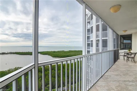 a view of a balcony with floor to ceiling windows with wooden floor