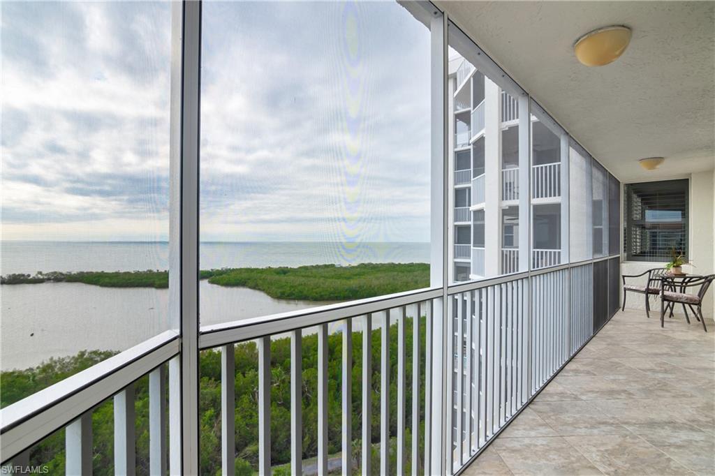 5550 Heron Point Drive, Unit 1804 Naples, FL 34108 - Photo 20 of 20 a view of a balcony with floor to ceiling windows with wooden floor