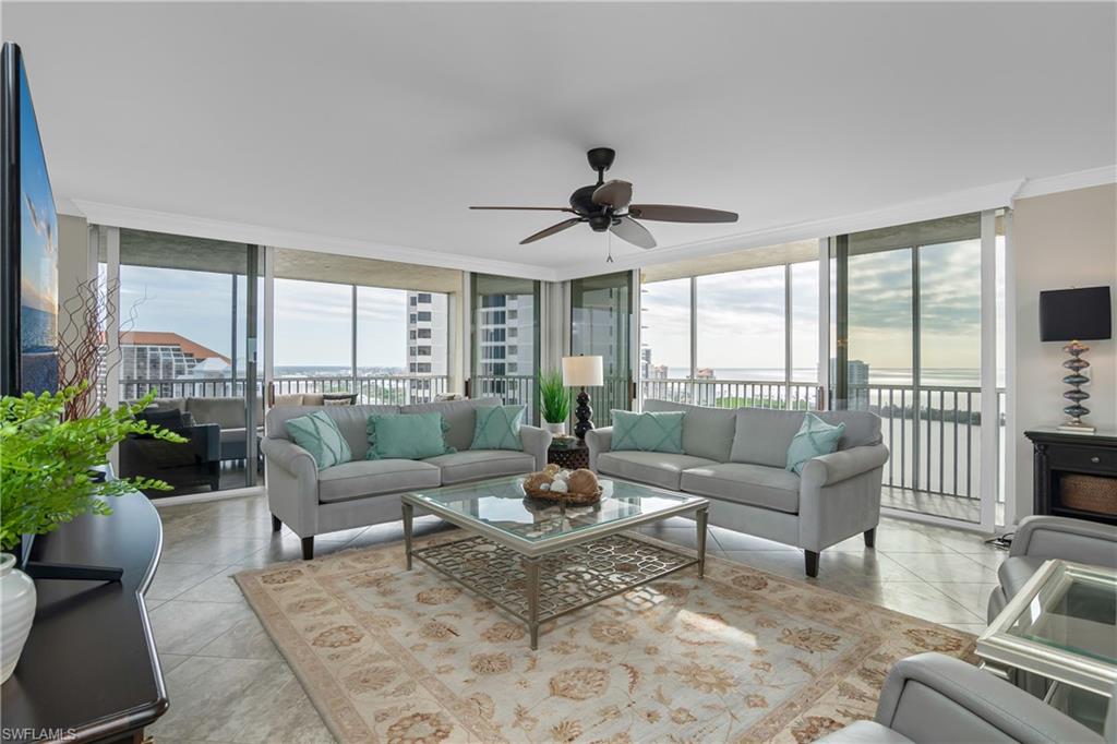 5550 Heron Point Drive, Unit 1804 Naples, FL 34108 - Photo 3 of 20 a living room with furniture and a large window