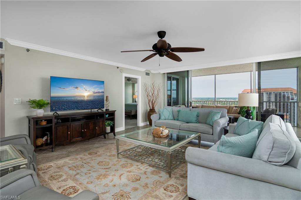 5550 Heron Point Drive, Unit 1804 Naples, FL 34108 - Photo 4 of 20 a living room with furniture and a flat screen tv