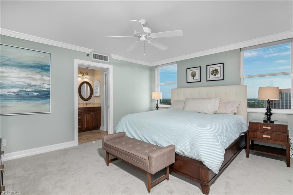 5550 Heron Point Drive, Unit 1804 Naples, FL 34108 - Photo 8 of 20 a spacious bedroom with a bed and a cabinets
