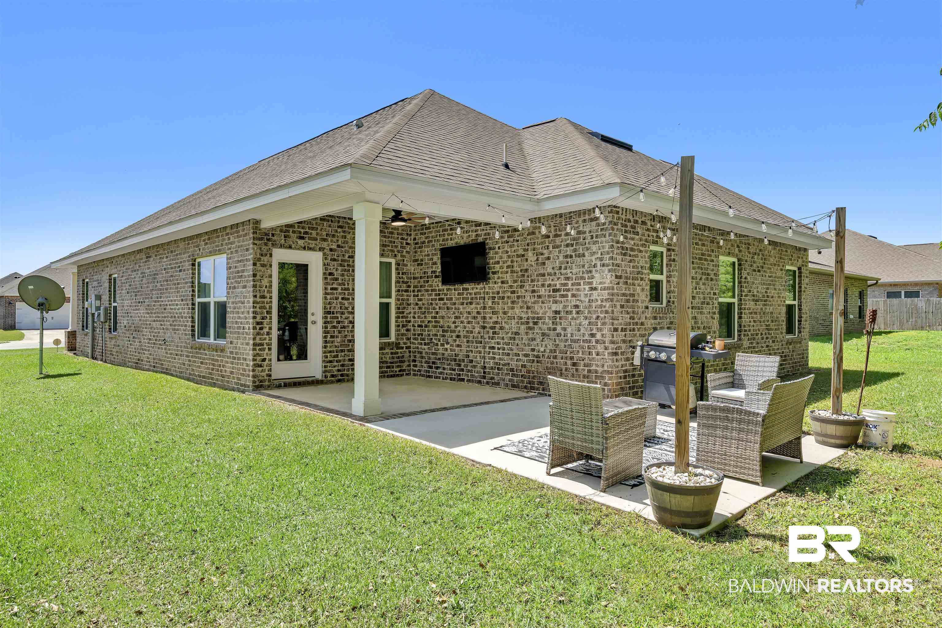 16504 Prado Loop Loxley, AL 36551 - Photo 34 of 45 Back of house with a patio area, a lawn, brick siding, and ceiling fan