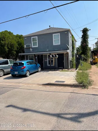 a view of building with car parked