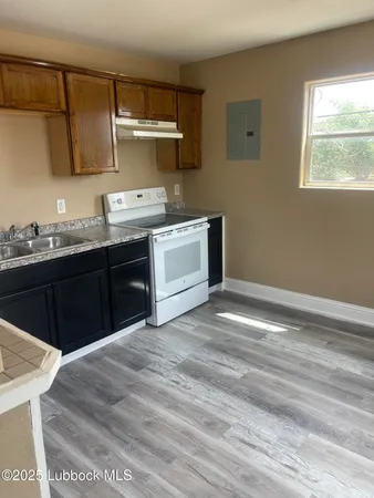 a kitchen with a sink cabinets and window