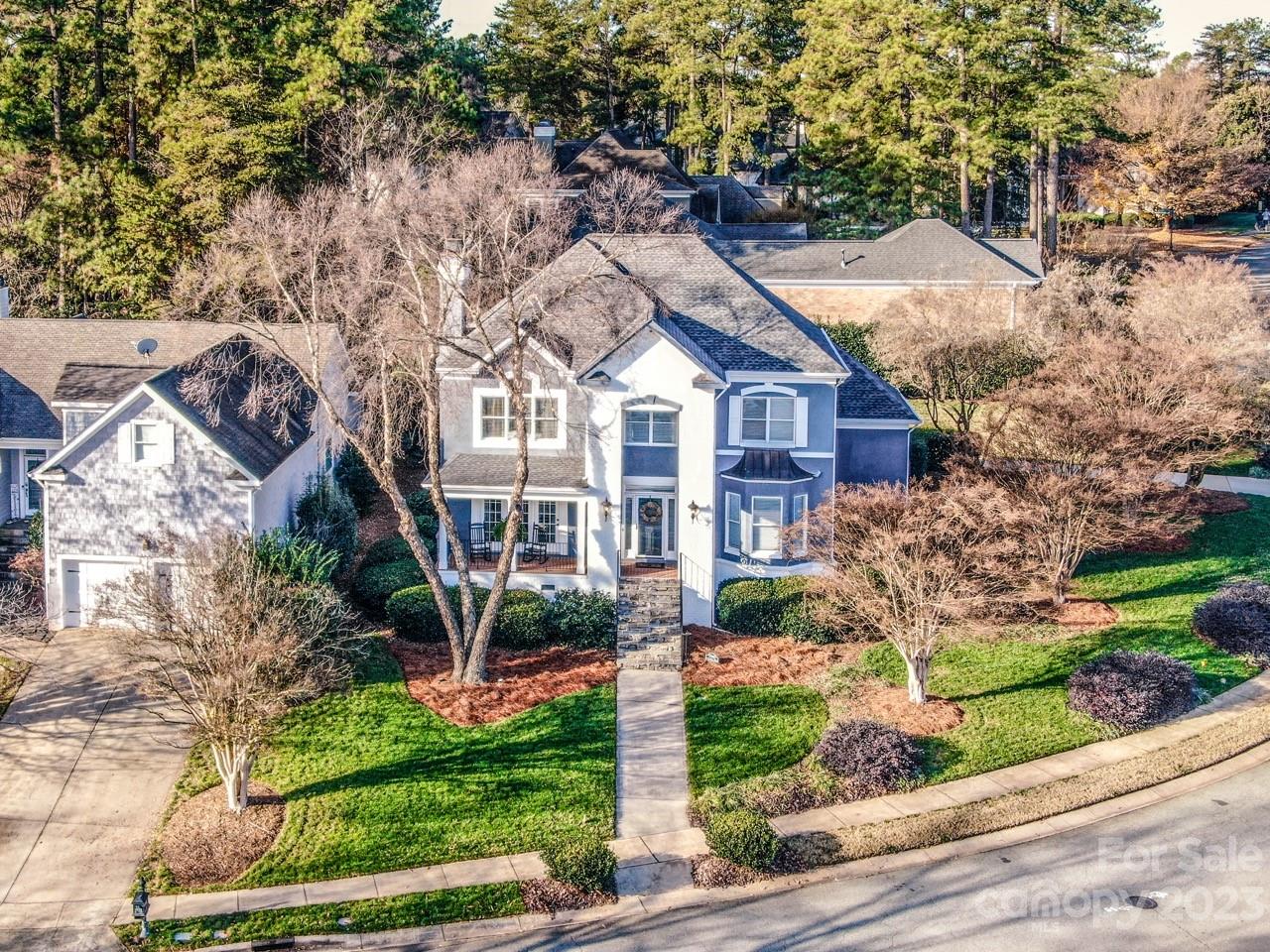 17506 Springwinds Drive Cornelius, NC 28031 - Photo 1 of 35 a front view of a house with a garden and plants