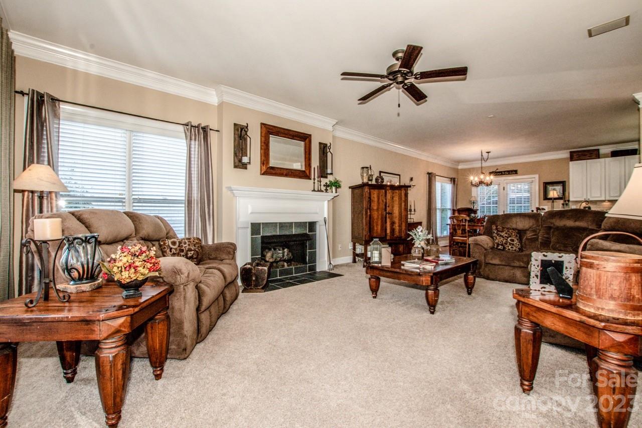 17506 Springwinds Drive Cornelius, NC 28031 - Photo 12 of 35 a living room with furniture and a fireplace