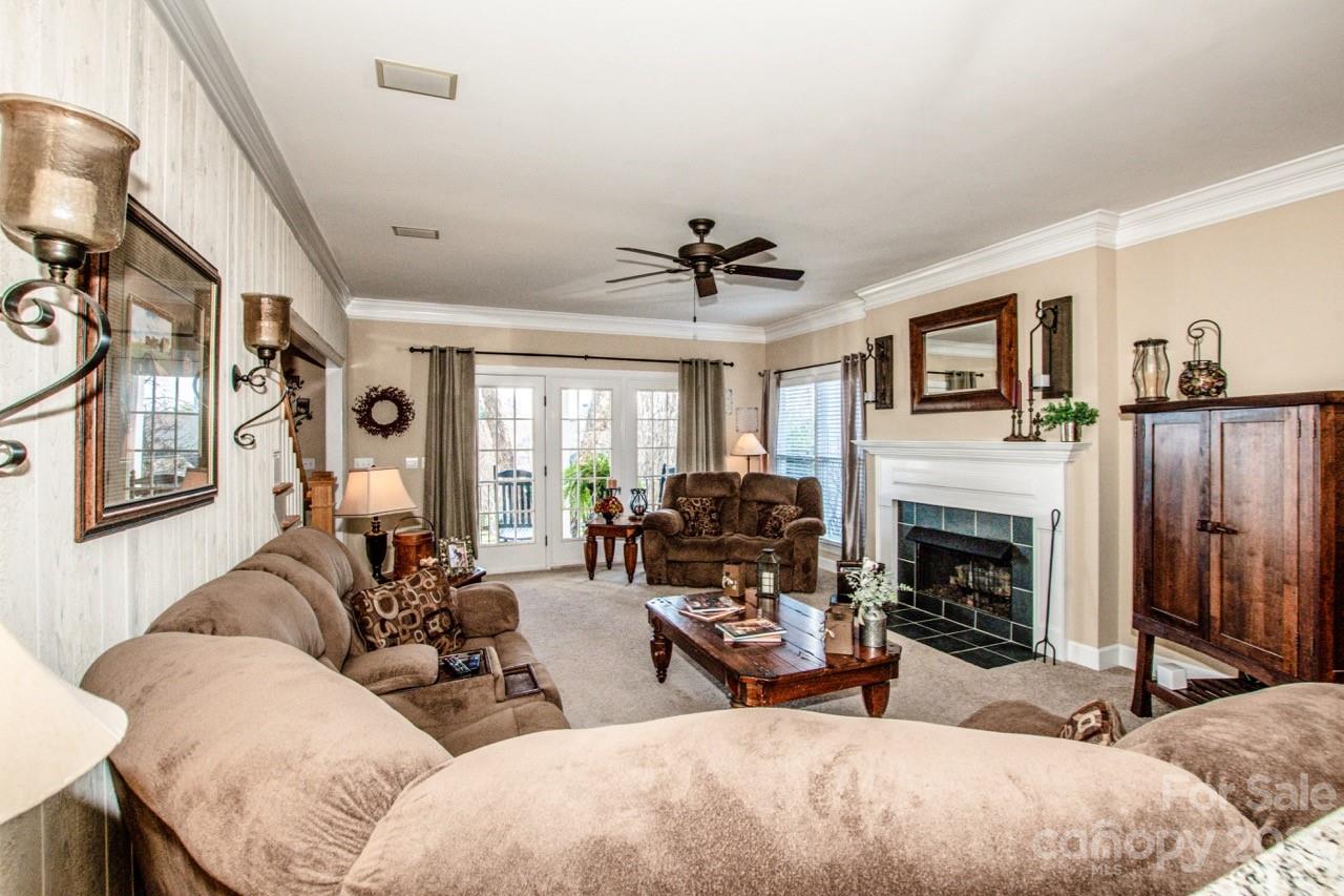 17506 Springwinds Drive Cornelius, NC 28031 - Photo 13 of 35 a living room with furniture and a fireplace