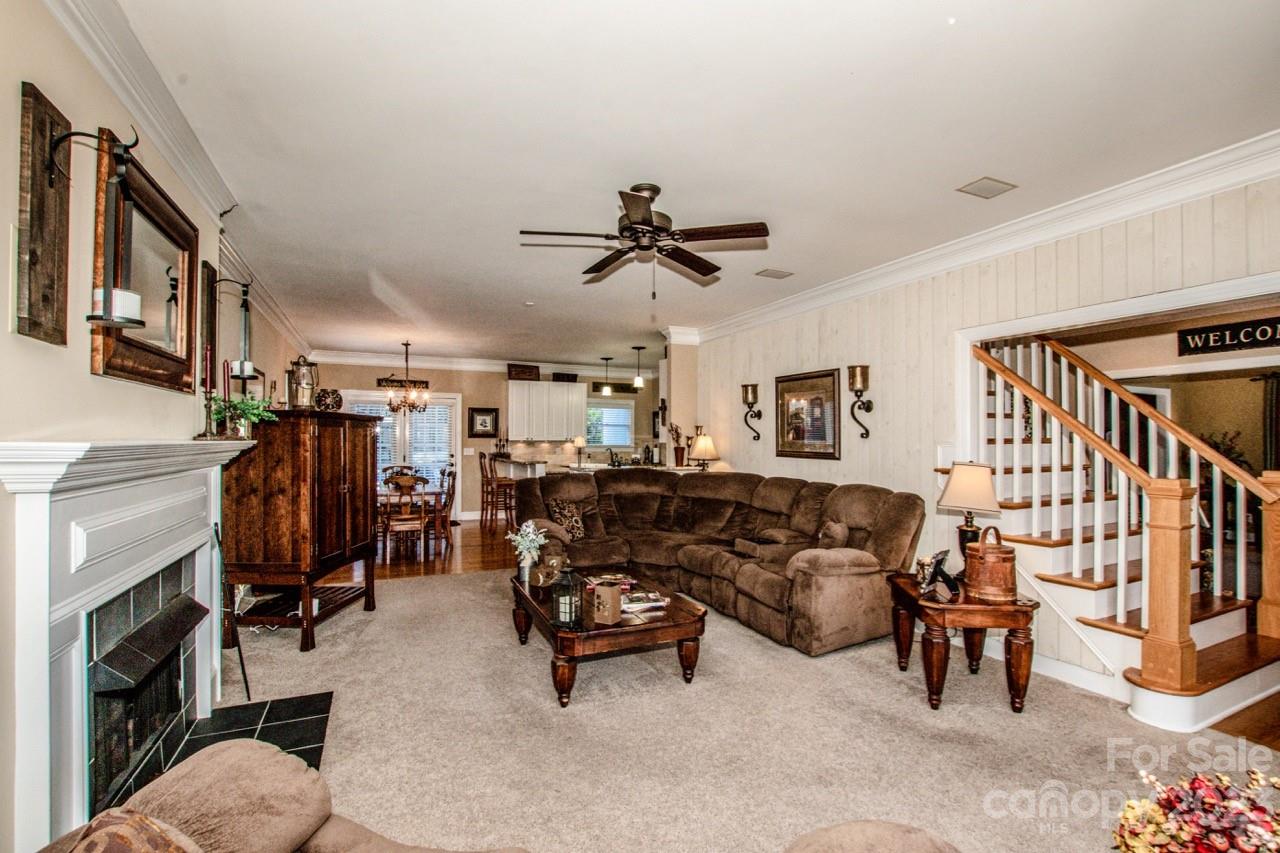 17506 Springwinds Drive Cornelius, NC 28031 - Photo 14 of 35 a living room with lots of furniture and a flat screen tv