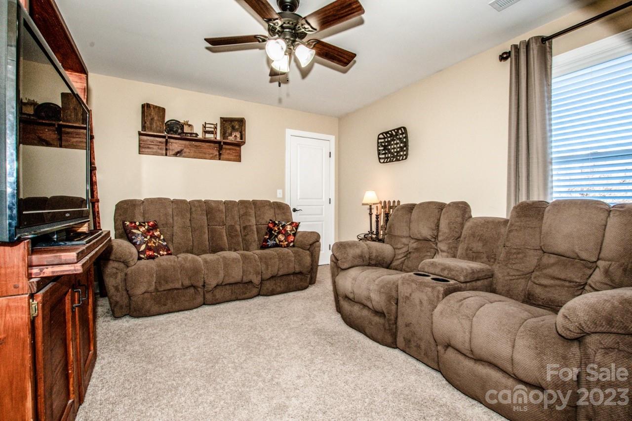 17506 Springwinds Drive Cornelius, NC 28031 - Photo 24 of 35 a living room with furniture and a flat screen tv