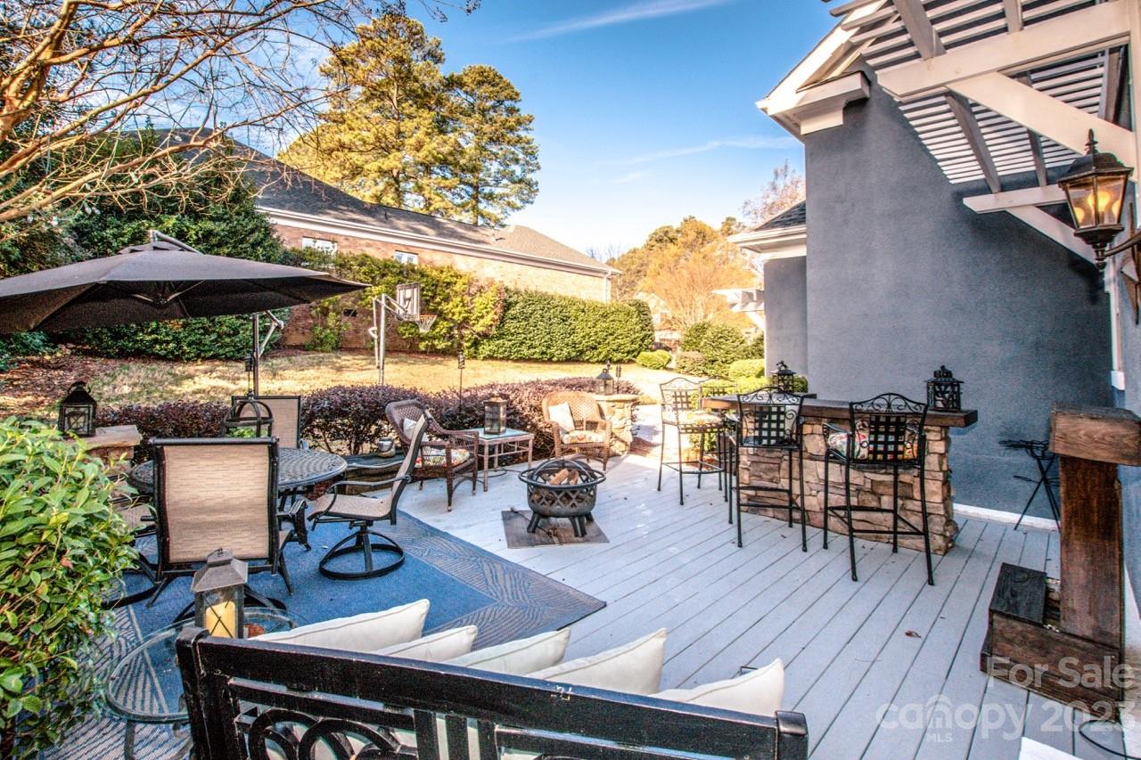 17506 Springwinds Drive Cornelius, NC 28031 - Photo 29 of 35 a view of a patio with table and chairs under an umbrella with wooden floor