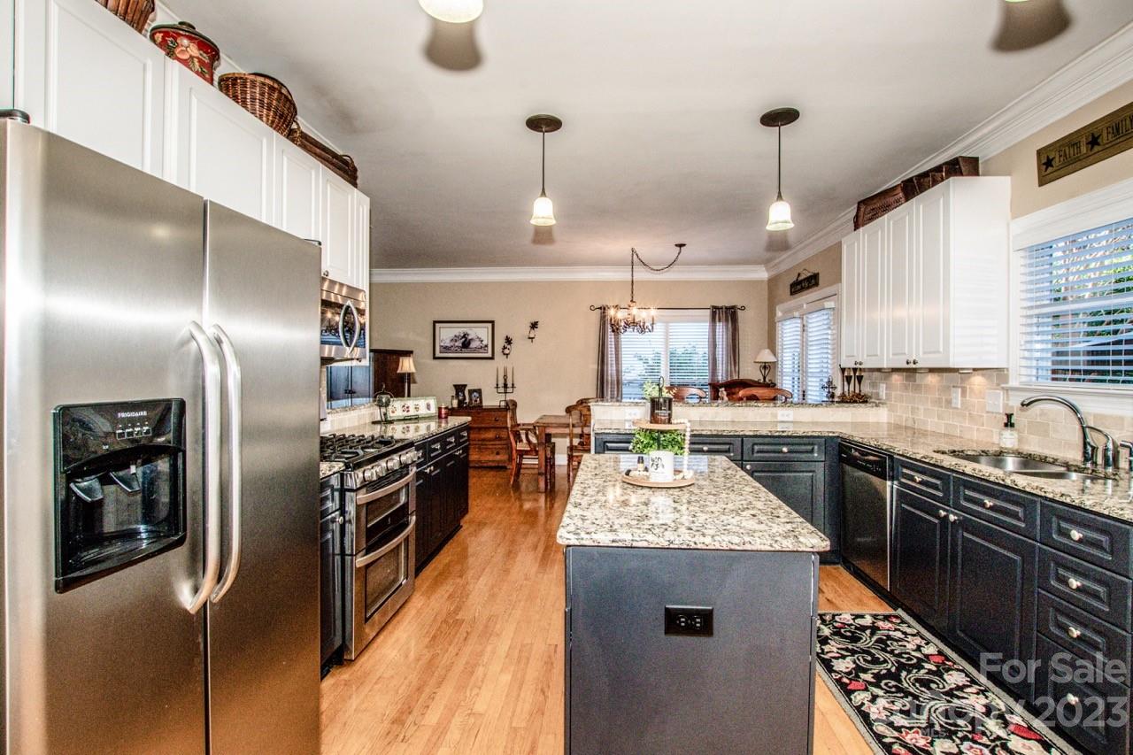 17506 Springwinds Drive Cornelius, NC 28031 - Photo 5 of 35 a kitchen with stainless steel appliances granite countertop a sink a stove and refrigerator