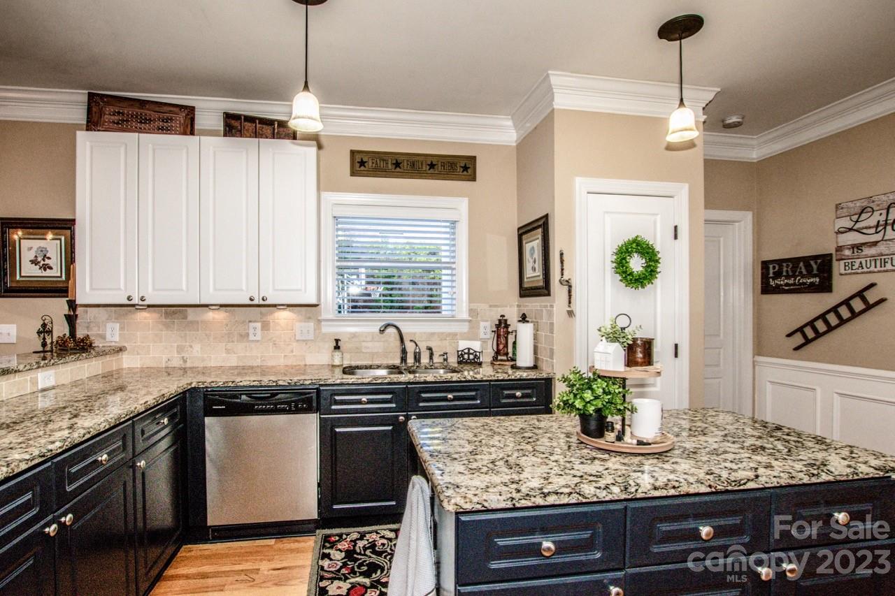 17506 Springwinds Drive Cornelius, NC 28031 - Photo 6 of 35 a kitchen with stainless steel appliances granite countertop a sink a stove and a wooden floor