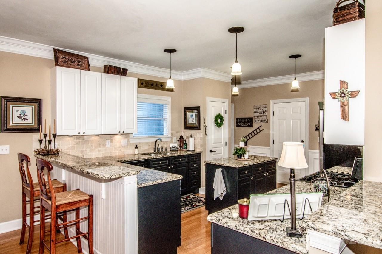 17506 Springwinds Drive Cornelius, NC 28031 - Photo 7 of 35 a kitchen with a sink stove and cabinets