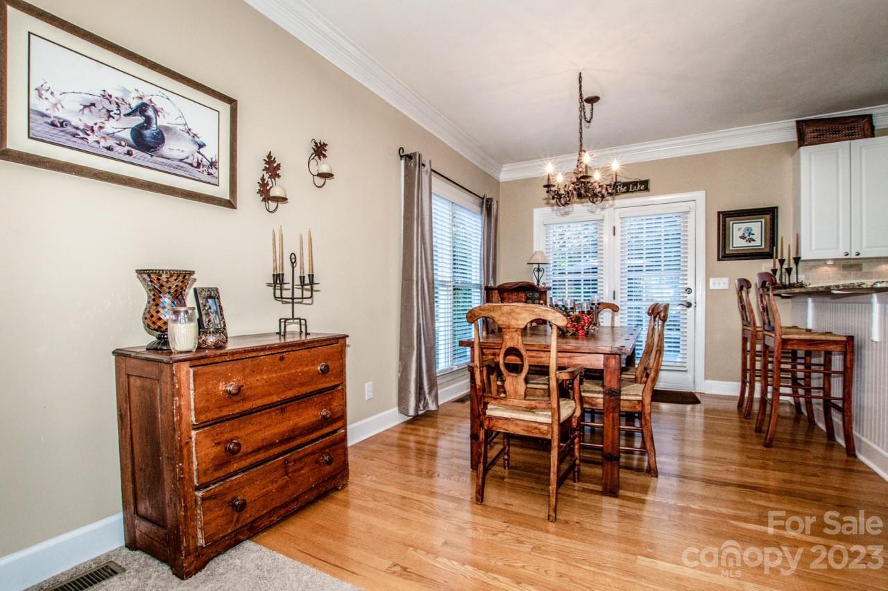 17506 Springwinds Drive Cornelius, NC 28031 - Photo 8 of 35 a dining room with furniture a chandelier and wooden floor
