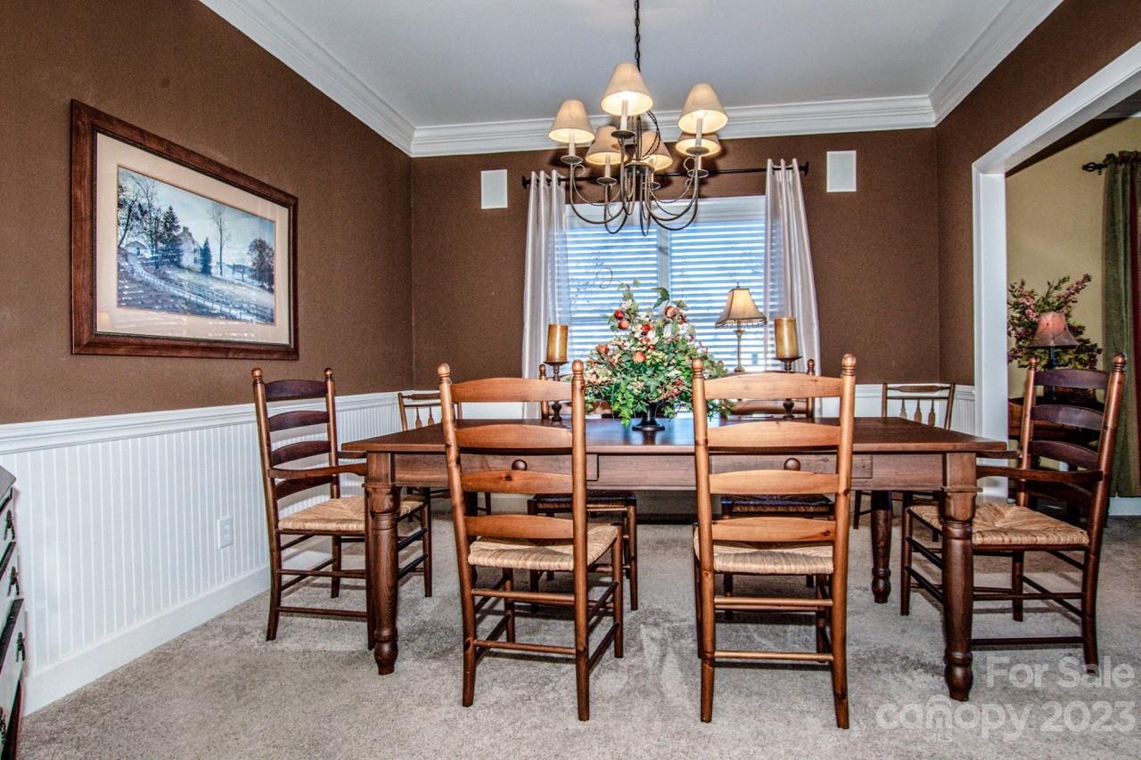 17506 Springwinds Drive Cornelius, NC 28031 - Photo 9 of 35 a dining room with furniture and chandelier