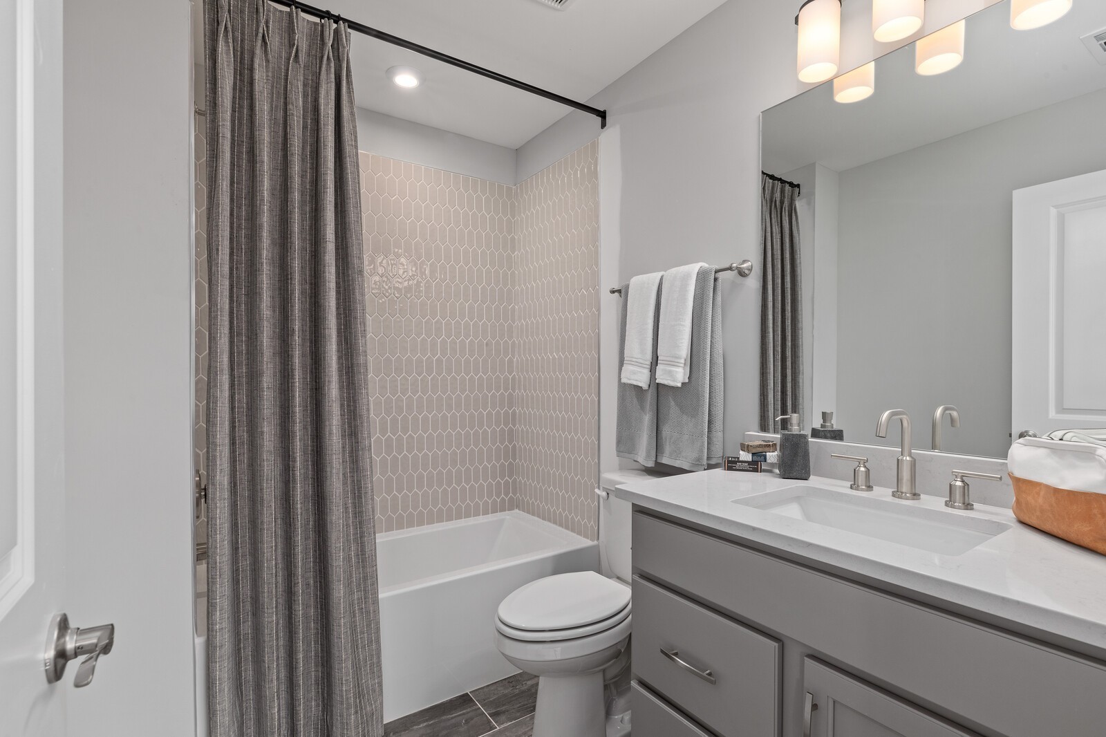 7272 Ruzek Court Fairview, TN 37062 - Photo 53 of 59 a bathroom with a sink a toilet a mirror and shower