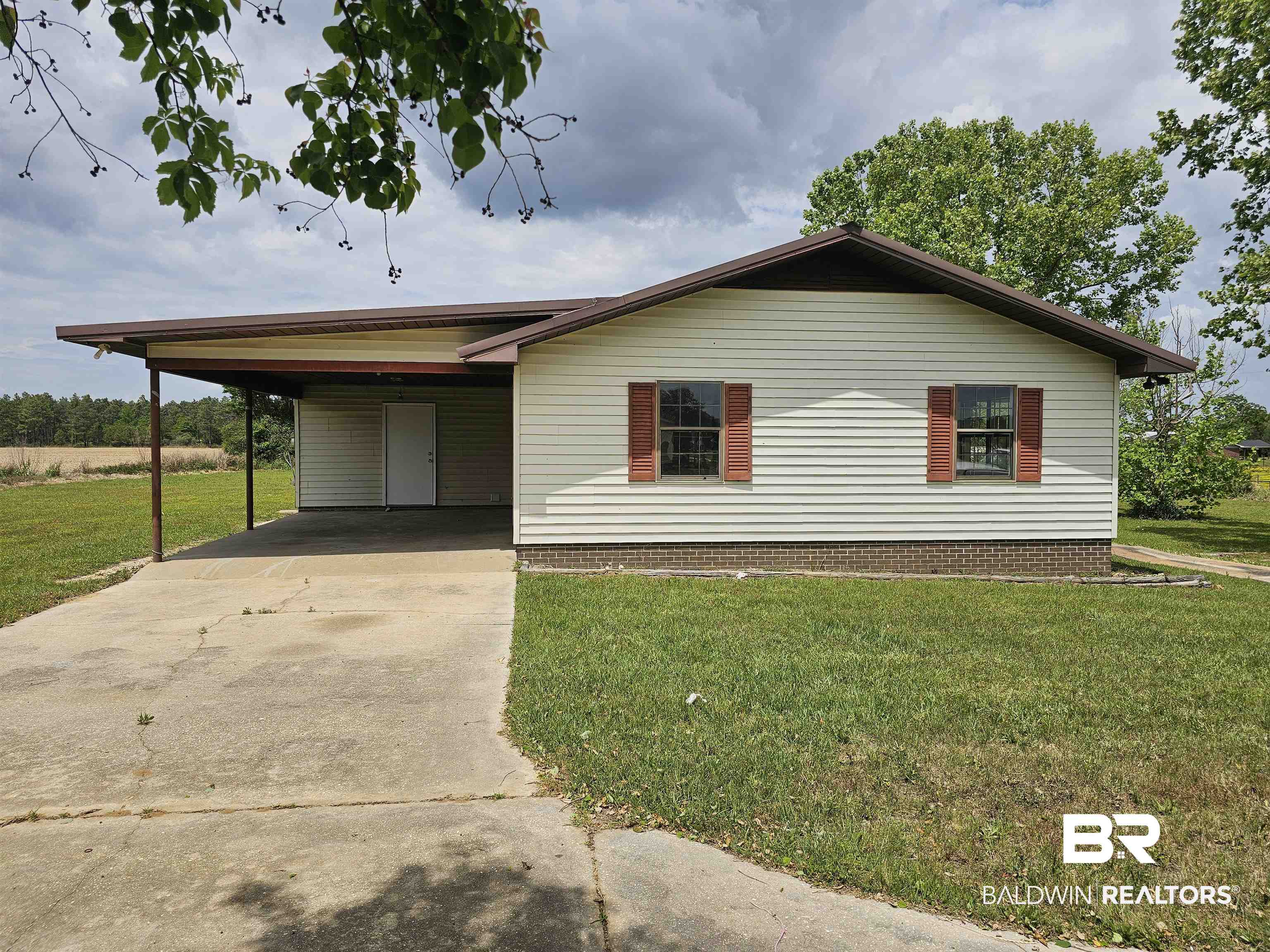 59575 Lottie Road Atmore, AL 36502 - Photo 6 of 23 Ranch-style home featuring concrete driveway, an attached carport, and a front yard
