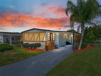 a front view of a house with a garden and yard