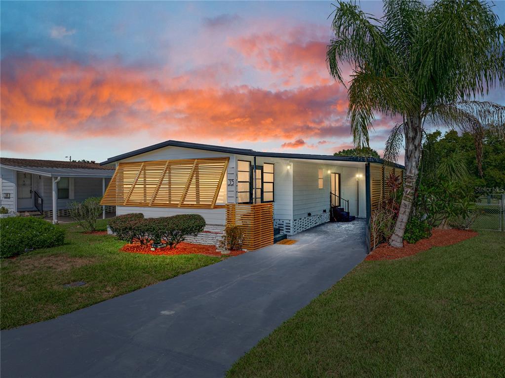 a front view of a house with a garden and yard