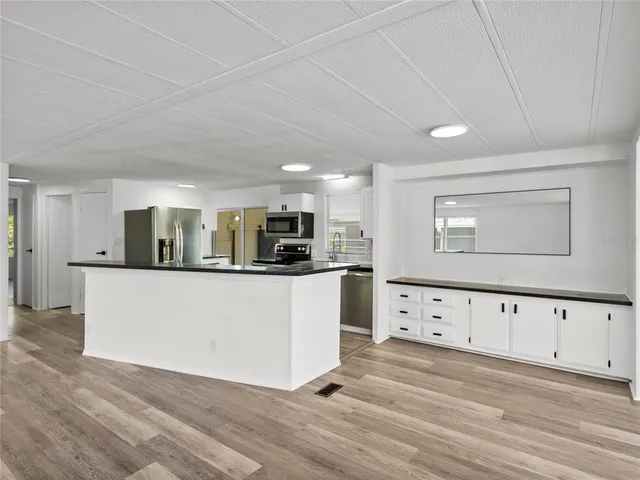a kitchen with stainless steel appliances a stove sink microwave and cabinets