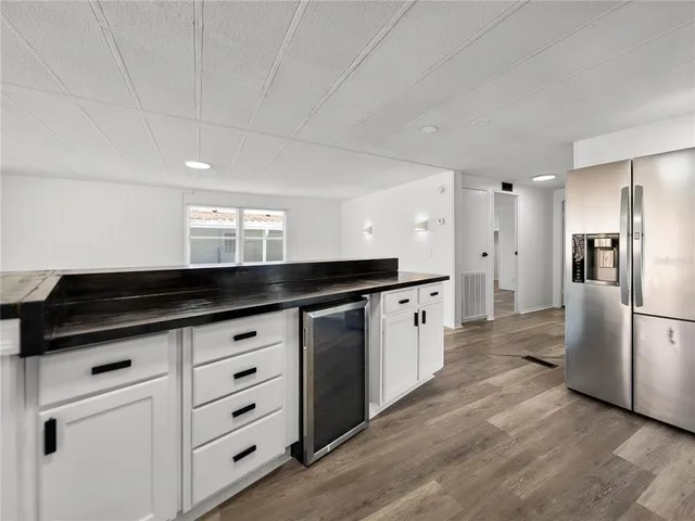a kitchen with granite countertop a sink stove and cabinets