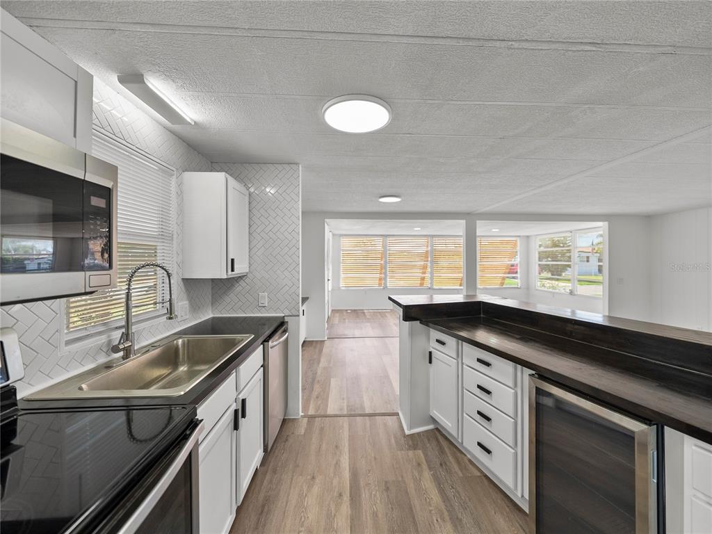 1610 Reynolds Road, Unit 35 Lakeland, FL 33801 - Photo 18 of 59 a kitchen with granite countertop a sink stove and cabinets