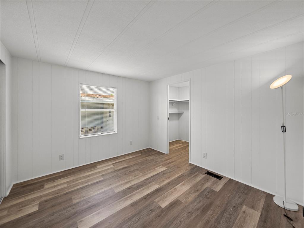 1610 Reynolds Road, Unit 35 Lakeland, FL 33801 - Photo 20 of 59 an empty room with wooden floor and windows