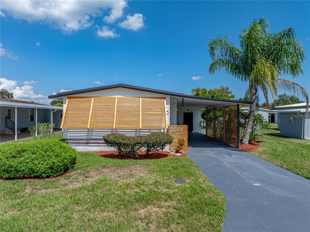 1610 Reynolds Road, Unit 35 Lakeland, FL 33801 - Photo 2 of 59 a front view of a house with a yard and garage