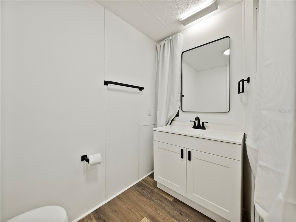 1610 Reynolds Road, Unit 35 Lakeland, FL 33801 - Photo 24 of 59 a bathroom with a sink toilet and mirror