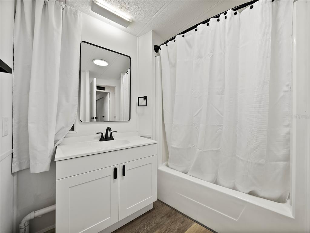 1610 Reynolds Road, Unit 35 Lakeland, FL 33801 - Photo 25 of 59 a bathroom with a sink a toilet and a mirror
